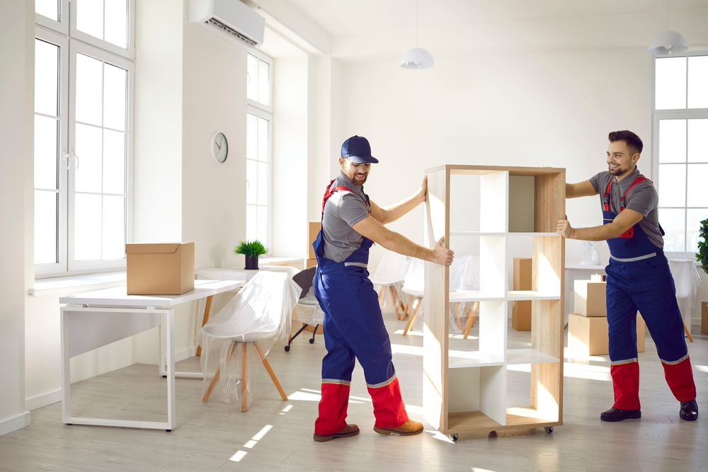 Two Giant movers employees moving furniture in the house